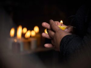 A close up of a person holding a candle next to other candles. Learn how a trauma therapist in Delray Beach, FL can offer support in coping with traumatic events. Contact a grief counselor in Palm Beach County, FL to learn more about the benefits of trauma therapy in Delray Beach, FL. 