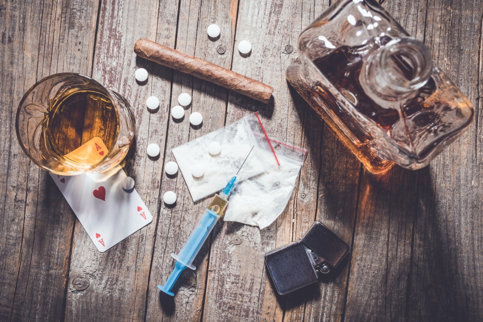 A top down view of drugs and alcohol of different kinds, representing the stress substance abuse counseling in Palm Beach, FL can address. Learn more about substance abuse counseling in Delray Beach, FL by contacting a substance abuse counselor in Palm Beach, FL today.