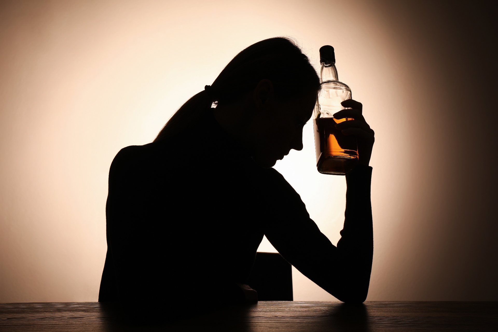 A silhouette of a woman holding an alcohol bottle against her head. A substance abuse counselor in Palm Beach, FL can offer support in overcoming substance use disorder symptoms in Palm Beach, FL. Learn more about substance abuse counseling in Delray Beach, FL today.