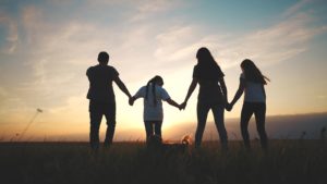 A family of four hold hands while walking towards the sunset. This represents the support substance abuse counseling in Palm Beach, FL can offer. Learn more about substance abuse treatment in Delray Beach, FL and other services by contacting an addiction therapist in Delray Beach, FL.