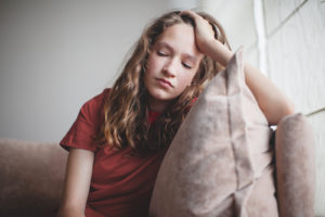 A girl rests her head against her hand with an upset expression. A grief counselor in Palm Beach County, FL can help you in managing grief symptoms in Palm Beach County, FL. Learn more about grief counseling in Delray Beach, FL today.