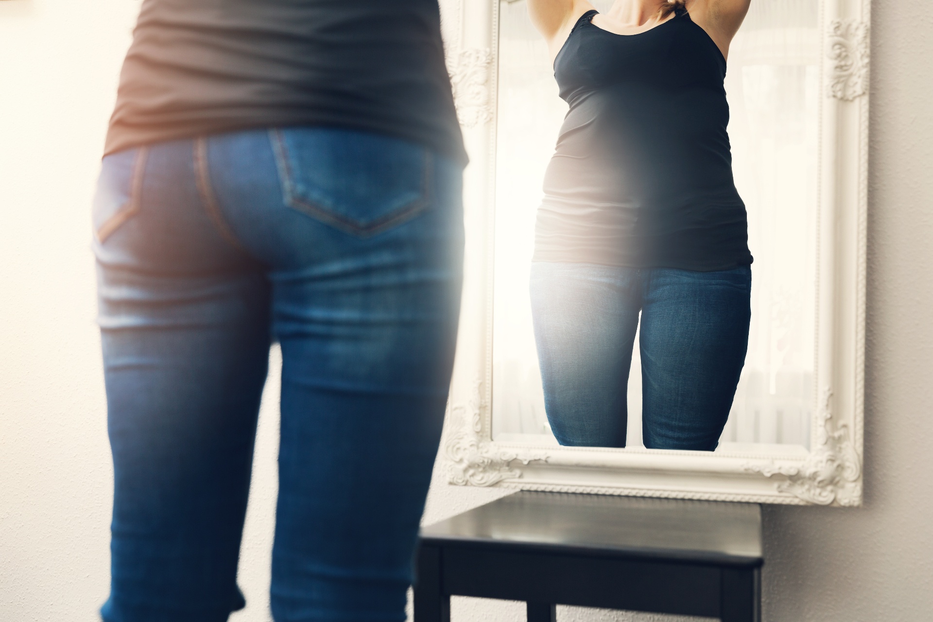 A close up of a person looking at themselves in the mirror. This could represent the focus on self body image counseling in Palm Beach County, FL can address. Learn more about counseling for body image issues in Palm Beach County, FL by contacting a therapist for body image issues today.
