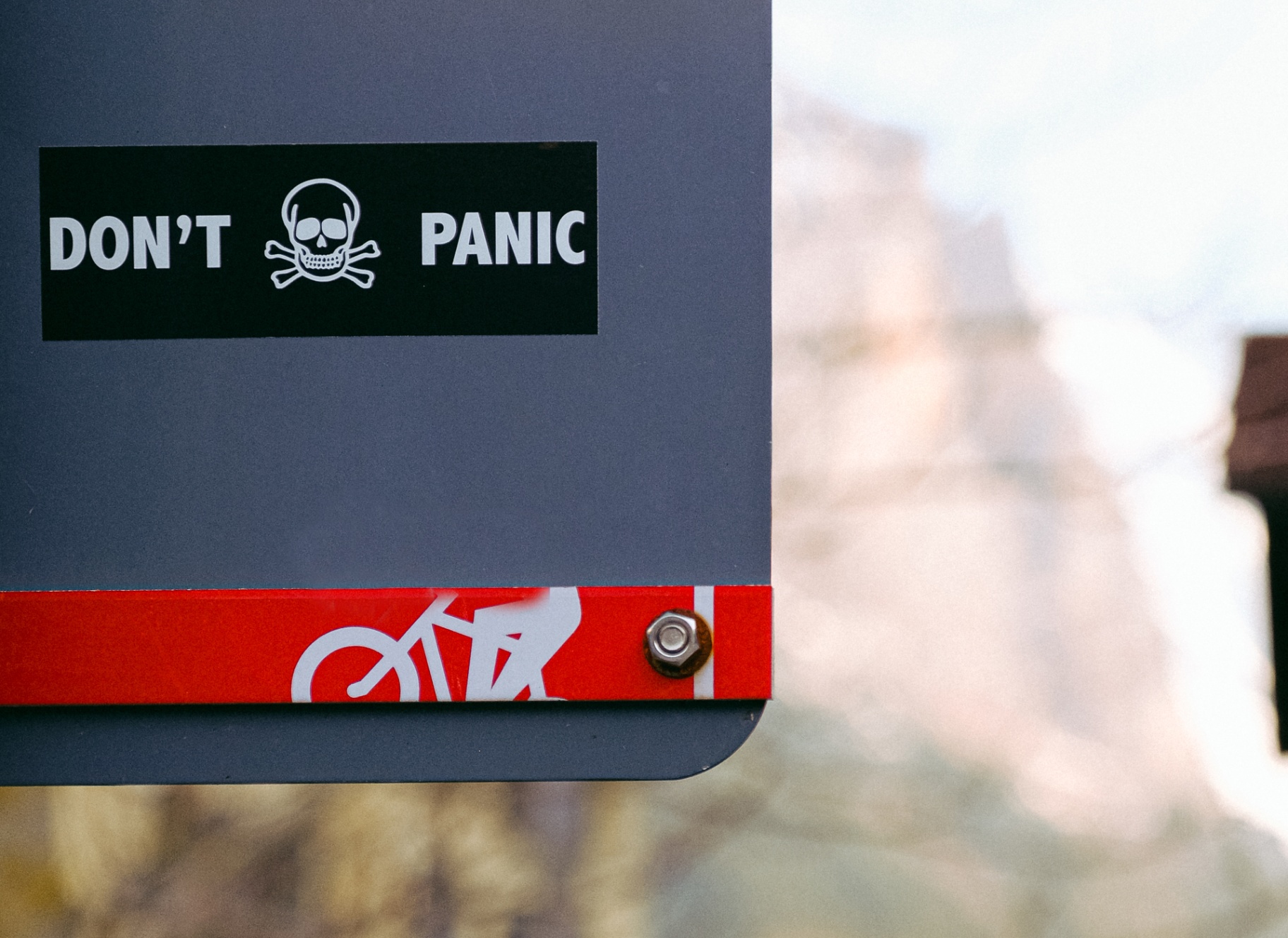A close-up of a street sign with a sticker reading “don’t panic.” Learn how an EMDR therapist in Palm Beach, FL can help you in addressing anxiety and panic attacks. Contact us to learn more about EMDR therapy in Palm Beach, FL and more. 