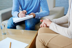 A person with a clipboard writes notes while a person gestures across from them. This could symbolize the support an EMDR therapist in Palm Beach, FL can offer. Contact them to learn more about EMDR in Palm Beach, FL, and other services to overcome anxiety. 