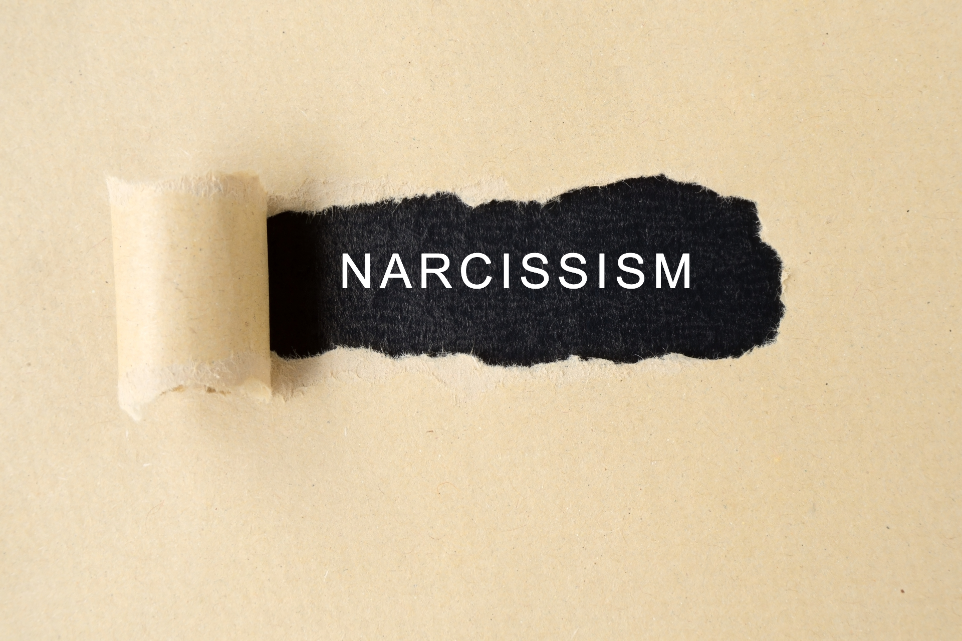 A close up of a ripped paper with the word narcissism. Learn more about how a narcissism therapist in Palm Beach, FL can offer support today by searching for online therapy in Florida.