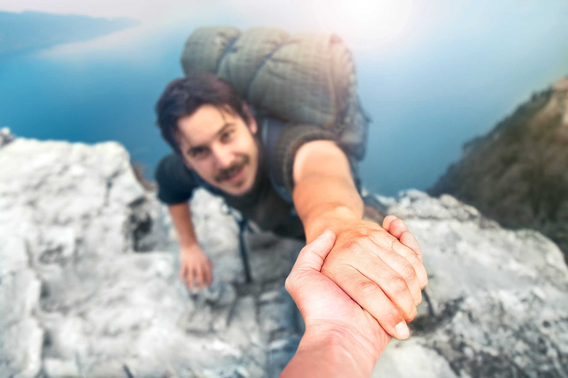 A close up of a hiker receiving a helping hand while walking up a cliff. Learn how online therapy in Florida can offer support for your mental health. Search for Delray Beach therapy and how an anger management therapist in Delray Beach, FL can help.