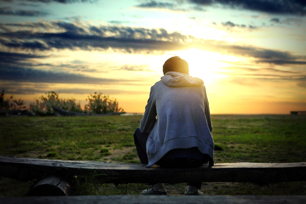 Shows a person sitting and watching the sunset. Represents how an emdr therapy in delray beach, fl can help support you with grief and loss in Florida today!