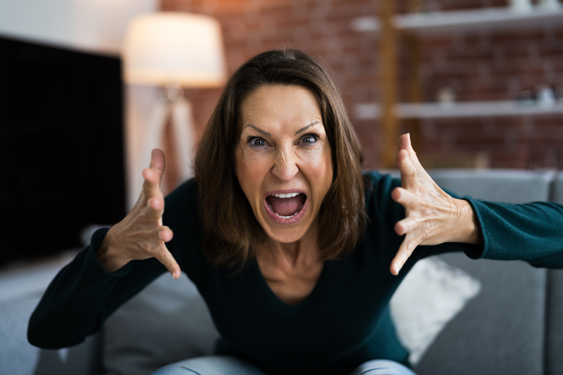 A woman yells while looking at the camera. Learn how an EMDR therapist in Palm Beach, FL can offer support with EMDR in Palm Beach, FL, and other services to treat anger. 