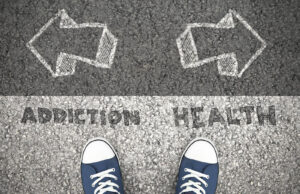 A close up of a person standing in front of two arrows pointing in opposite directions saying “addiction” and “health”. Contact an addiction therapist in Palm Beach, FL to learn more about types of addiction in Palm Beach, FL. Substance abuse treatment in Delray Beach, FL can offer support for you and your loved ones.