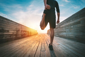 A person stretches their leg before a morning jog. This can represent self-care that an EMDR therapist in Palm Beach County, FL can help you cultivate. Learn more about EMDR therapy in Delray Beach, FL by contacting a trauma therapist in Delray Beach, FL. 