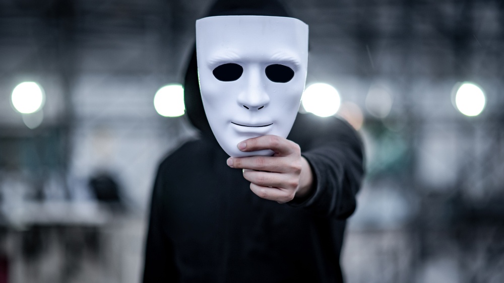 A close up of a person holding a mask in front of their face toward the camera. Learn how an anxiety therapist in Palm Beach County, FL can offer support by searching for anxiety treatment in Palm Beach County, FL. A trauma therapist in Miami, FL can support you today.
