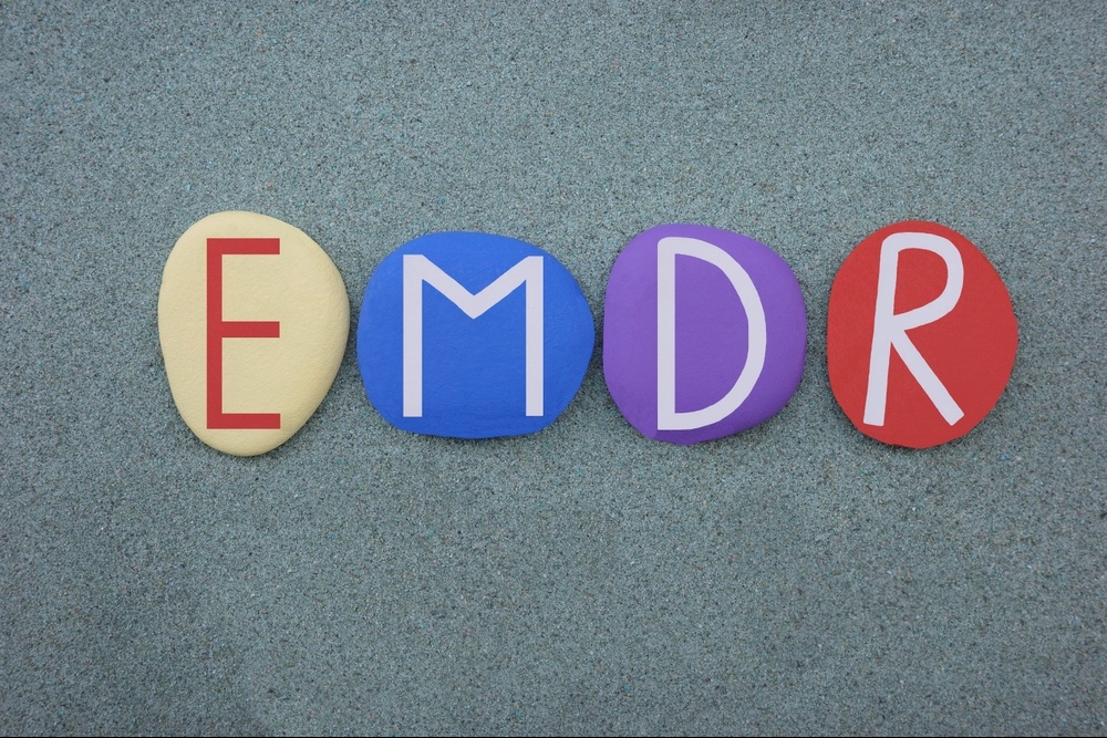 A close up of multicolored pebbles spelling EMDR. Search for a trauma therapist in Delray Beach, FL for support with coping with past pain. Learn more about EMDR in Palm Beach County, FL and trauma treatment in Palm Beach, FL today. 