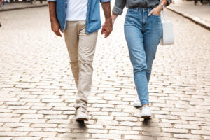 A couple holds hands while walking down a cobblestone road while holding hands. Learn how a therapist in Palm Beach County, FL can offer support with Palm Beach County, FL therapy and the benefits for your relationship. Search for a therapist in Delray Beach, FL today. 