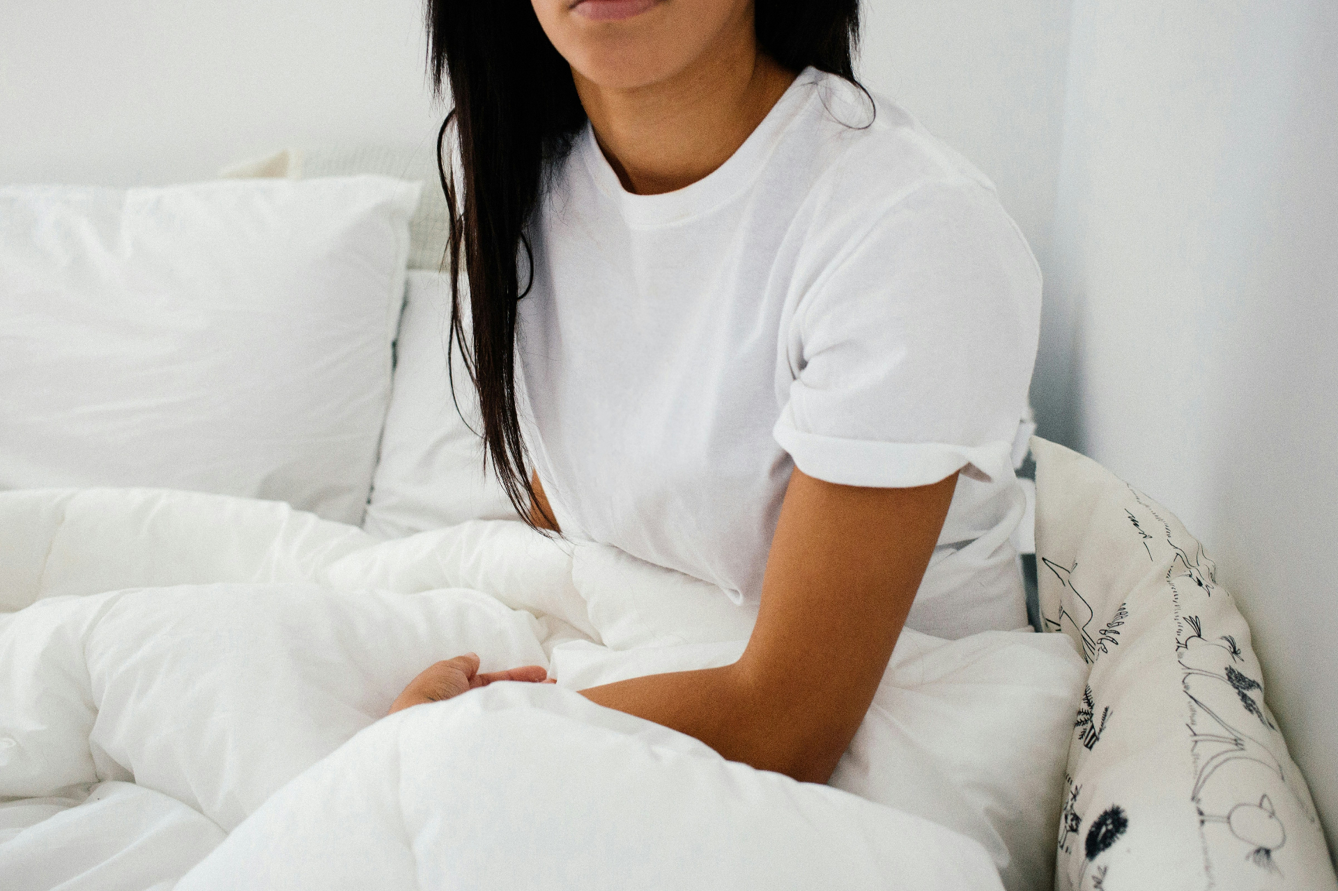 A women sits in bed with blankets covering her mid-lower half. This could represent overcoming the need for being in love. Learn how an addiction therapist in Palm Beach County, FL can offer support with addiction counseling in Delray Beach, FL or by searching for "addiction therapist Palm Beach" today. 