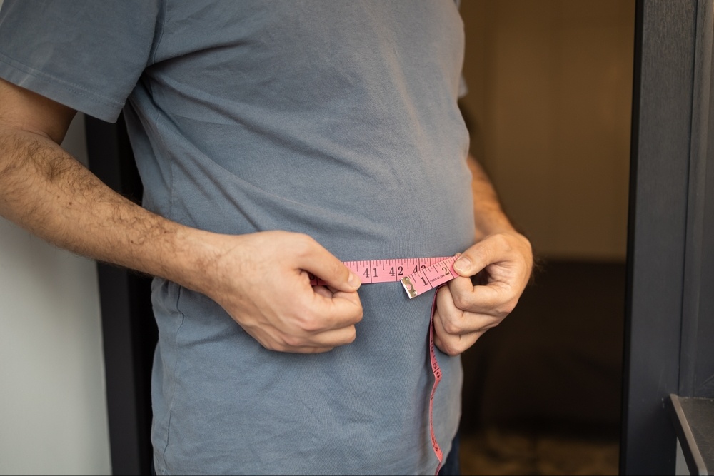 A close up of a person wrapping a measuring tape around their stomach. Learn how mental health support can help assist weight loss drugs and coping with eating disorders. Contact a binge eating therapist in Delray Beach, FL to learn more about the support that Palm Beach County, FL therapy can offer today.